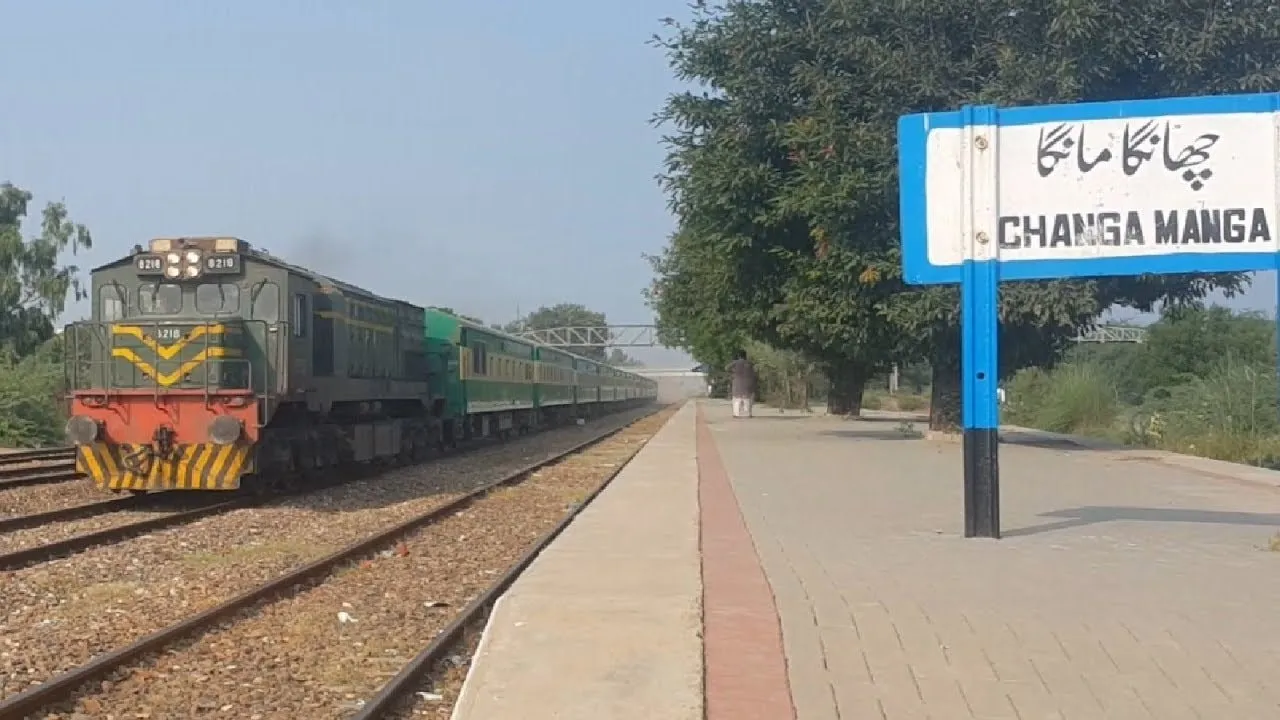 A Pakistan Railways mainline train arriving at Changa Manga railway station, the station sign visible